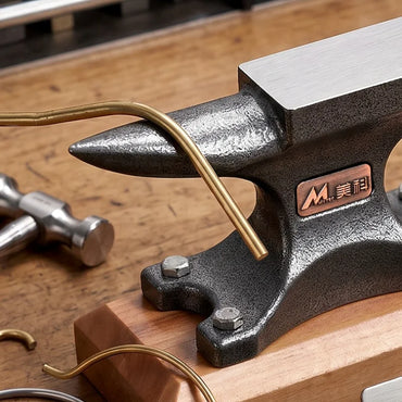 Close-up of the anvil horn with a brass wire being formed