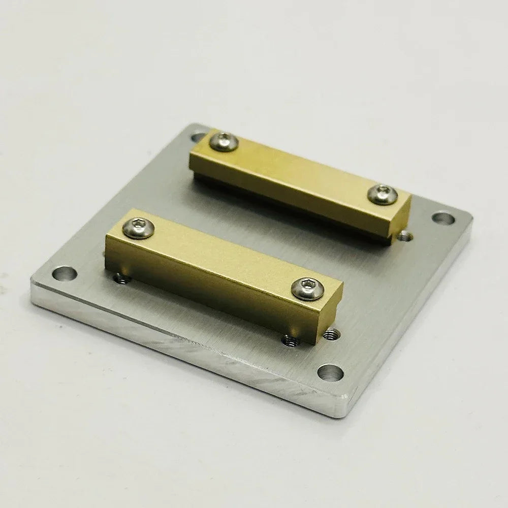 Aluminium plate 60 by 60 mm with two brass rails bolted across the top