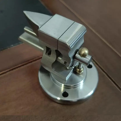 Mini bench vise on its round swivel base, jaws tilted