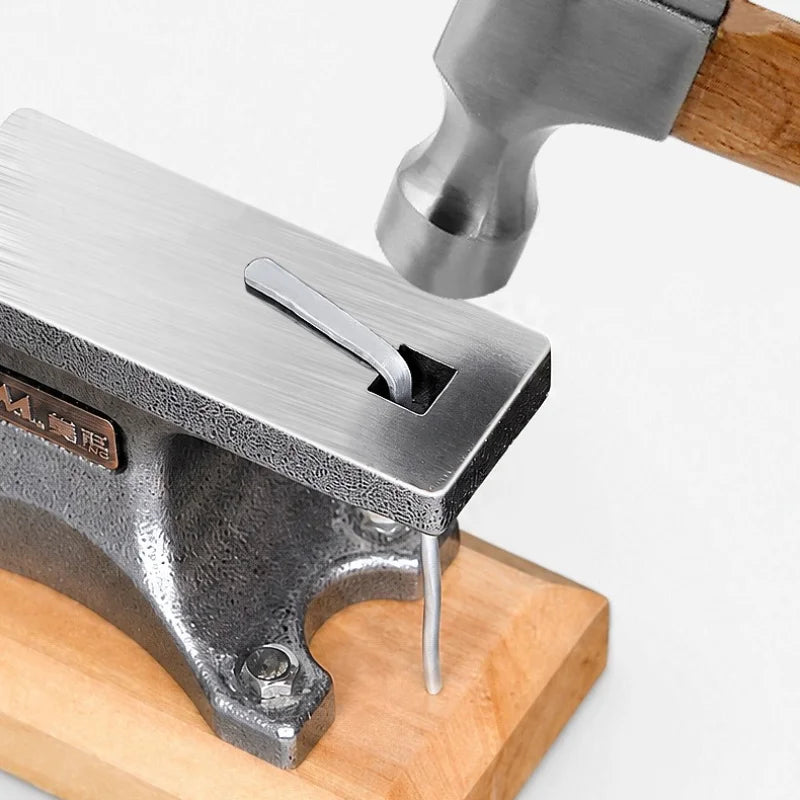 Hammering a pin on the anvil face over the hardy hole