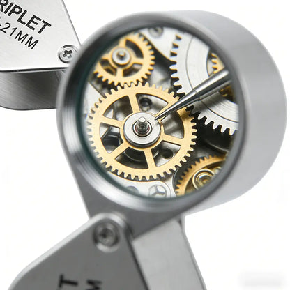 Looking through the loupe at the gear train of a watch movement