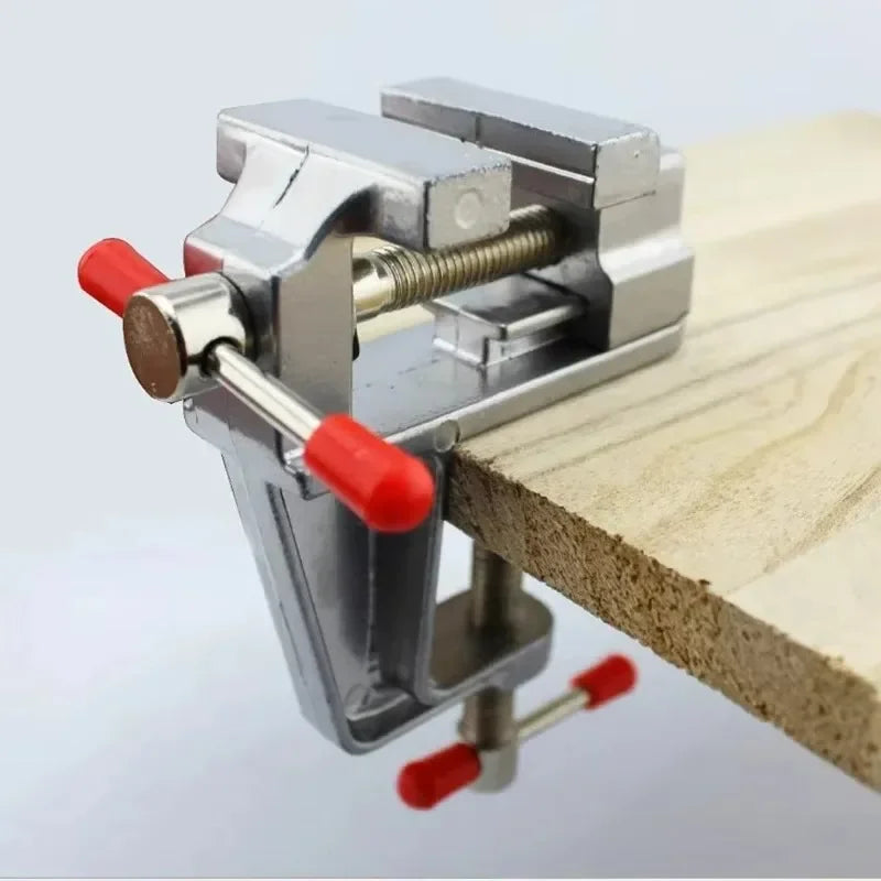 Clamp-on bench vise clamped to a table edge
