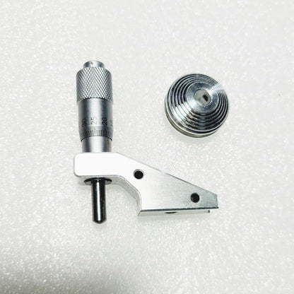 The micrometer head beside the seven groove cone pulley