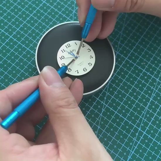 Watch hand pressers shown in use