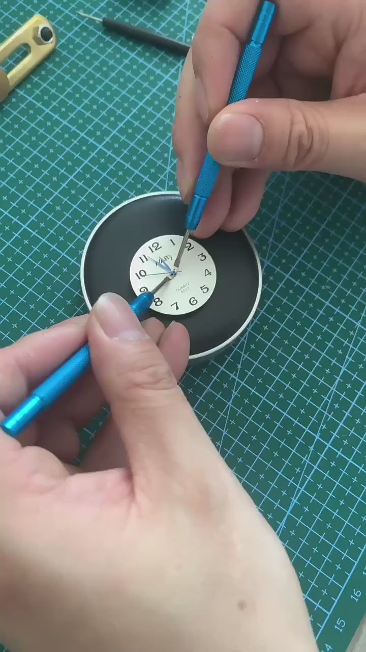 Watch hand pressers shown in use